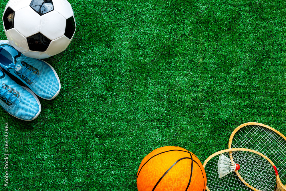 Flat lay of sport balls - football, basketball on grass top view copy space