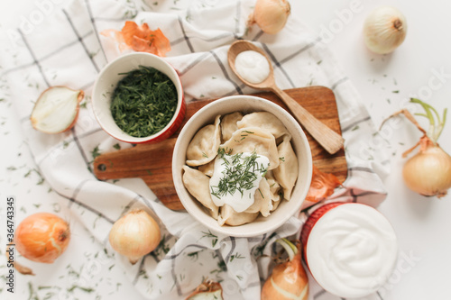 dumplings with potatoes and onions with sour cream and herbs