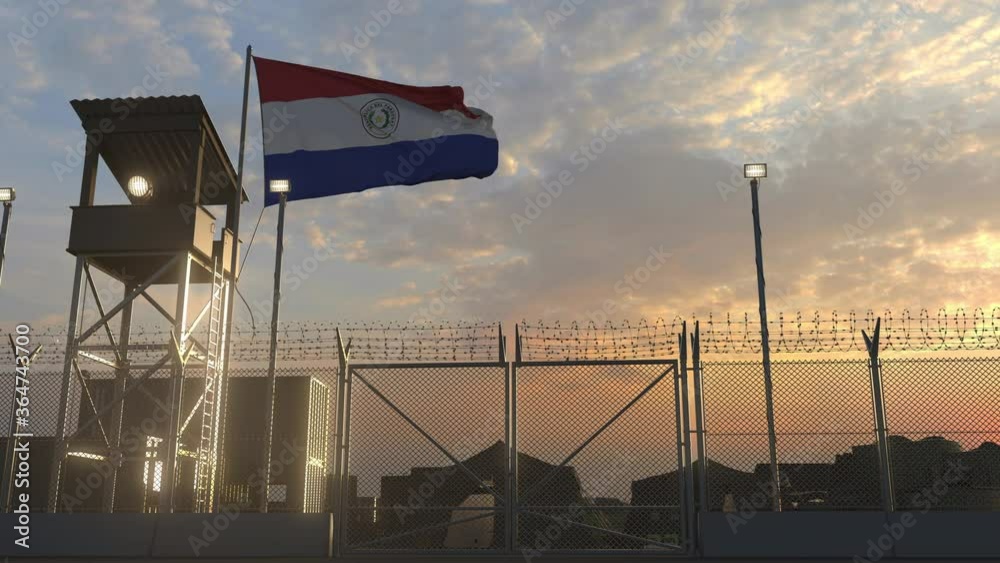 Waving flag of Paraguay above military base in the evening