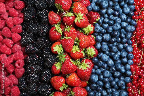 Mix of different ripe tasty berries as background, top view