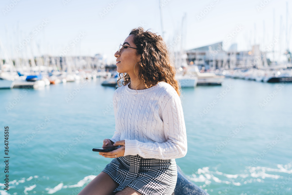 Young lady using mobile phone near sea port Young lady using mobile phone near sea port