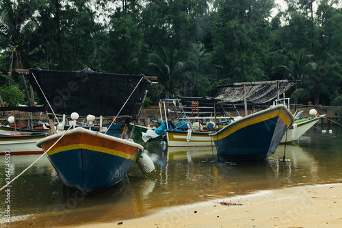 Beautiful view at Traditional fishing village with lovely sky and fishing boat moored near the shore © amirul syaidi