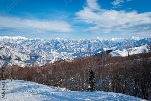 view from top mountain, white snow and beautiful landscape during winter season in Japan against blue sky background