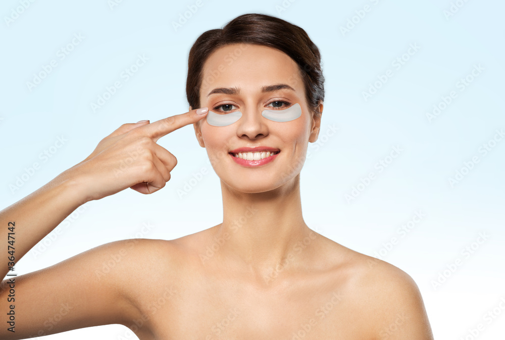 beauty, cosmetology and rejuvenation concept - beautiful young woman with hydrogel under-eye patches over blue background