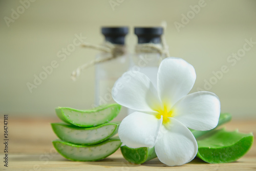 Aloe vera Fresh stacked with drop water and aloe vera juice in glass bowl with honey in jar on old wood