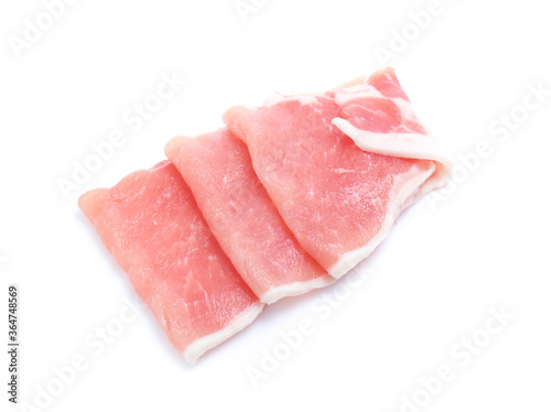 Raw pork meat with parsley herb leaves isolated on white background