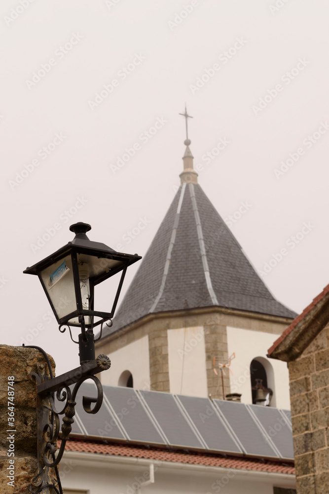 Tower and lamppost in the Sanctuary of Nuestra Señora del Castañar, in Bejar, Salamanca, Castilla Leon, Spain. Europe. Construction.