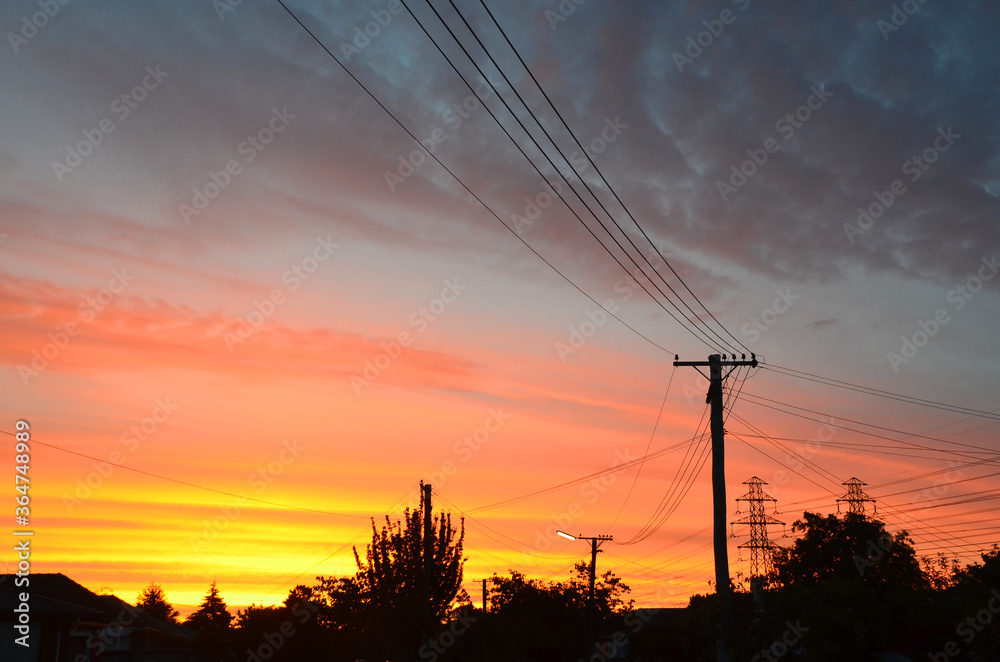 Dramatic sunset with beautiful gradient colour and silhouette of cables and wire at South Island of New Zealand.