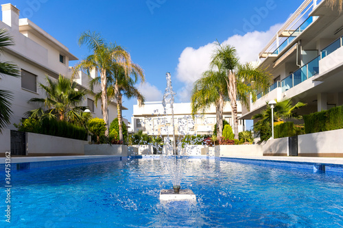 Pool in a condominium with blue water on a sunny day.