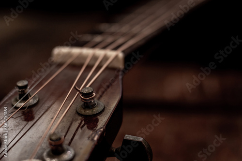 Close up Head stock of old acoustic guitar. Vintage style photo