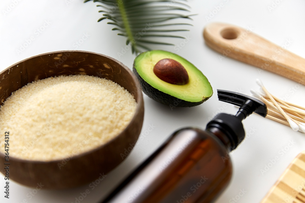 natural cosmetics, sustainability and eco living concept - avocado, sea salt in bowl, liquid soap or shower gel and cotton swabs on white background natural cosmetics, sustainability and eco living concept - avocado, sea salt in bowl, liquid soap or shower gel and cotton swabs on white background