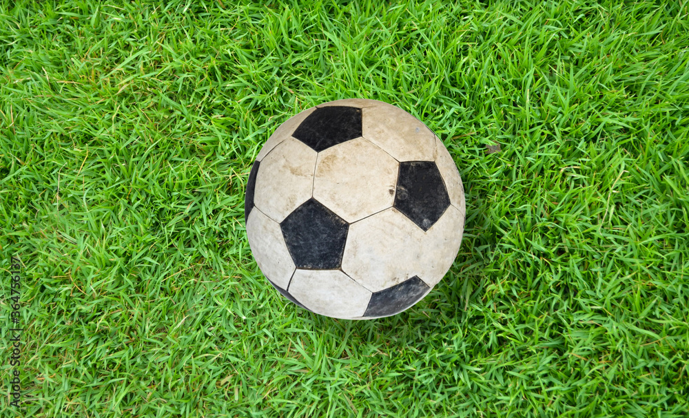 Fototapeta premium Old football on green artificial feild.