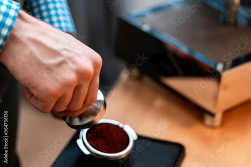 Close Up Of Barista Hands Holding Portafilter With Ground Coffee. Coffee Preparation At Home. Good Coffee Without Leaving Home