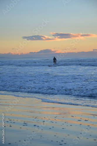 A surfer surfing at the New Brighton Beach. It's a best spot to visit for sunrise