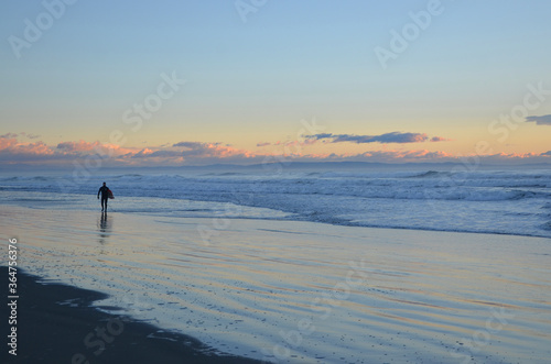 A surfer surfing at the New Brighton Beach. It's a best spot to visit for sunrise