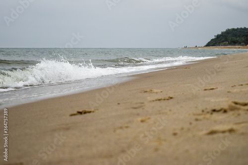 Fototapeta Naklejka Na Ścianę i Meble -  White waves and sandy beach of the Baltic Sea