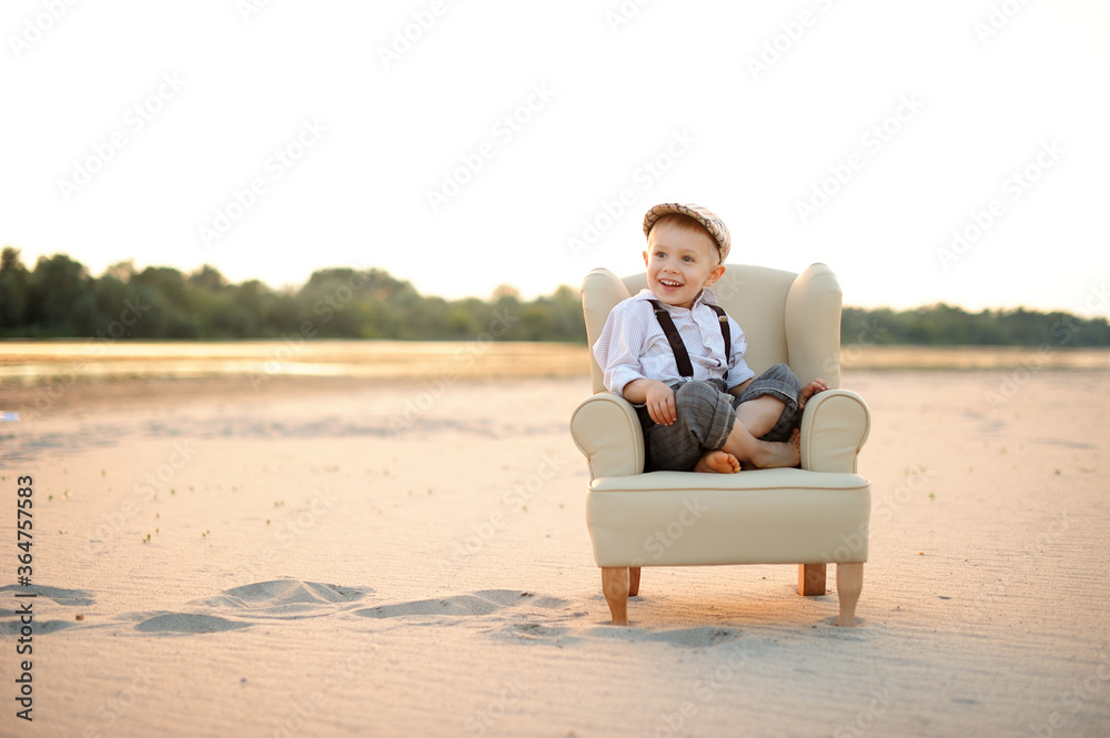 Smiling child, little boy on the summer beach.