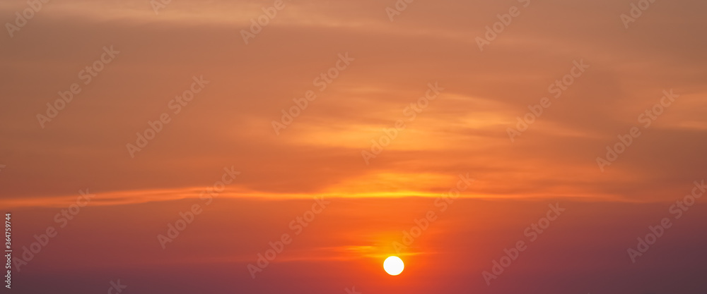 summer background with sunset in the orange sky and clouds background texture banner