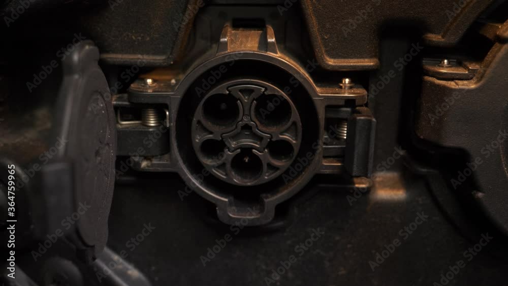 Connecting a charging gun to a car using the SAE J1772 charging port