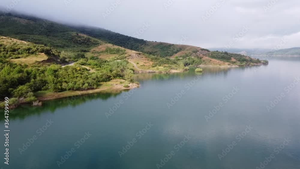 Drone view of lake in fog, mountain and island Drone view of lake in fog, mountain and island