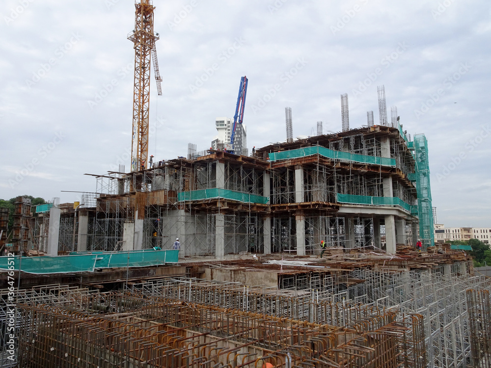 SEREMBAN, MALAYSIA -MARCH 7, 2020: Steel reinforced concrete structure is built at the construction site. Built using formworks made of wood and plywood. Manually build by the workers.