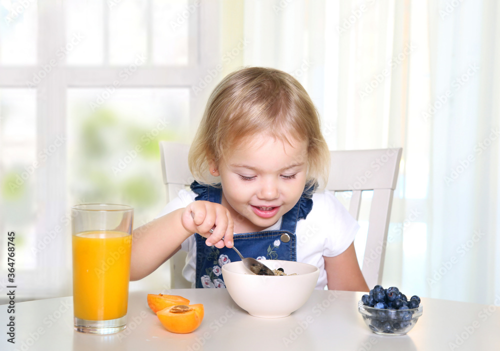 Child eating fruits and oatmeal.Kid have morning breakfast.Healthy nutrition. Child eating fruits and oatmeal.Kid have morning breakfast.Healthy nutrition.