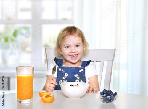 Child eating healthy food fruits and vegetable's,kid's nutrition.Caucasian kid smiling have a meal.