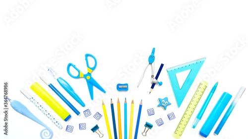 Stationary supplies in yellow and blue colors for school, university, office on white background. Empty space. Flat lay, banner.