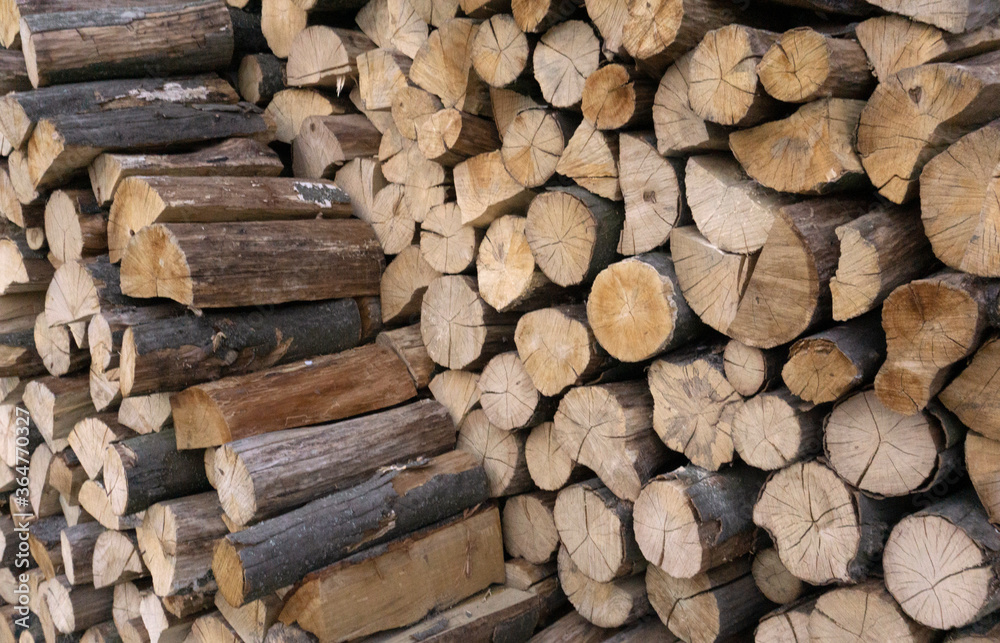 Stack of old firewood texture background. Firewood for the winter, stacks of firewood, pile of firewood. Fireplace wood, cordwood, splitwood.stored logs, wood and lumber. Stack of old firewood texture background. Firewood for the winter, stacks of firewood, pile of firewood. Fireplace wood, cordwood, splitwood.stored logs, wood and lumber.