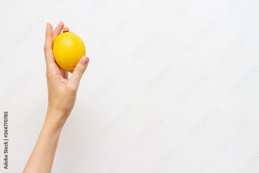 Woman holding fresh lemon, free space for text Woman holding fresh lemon, free space for text