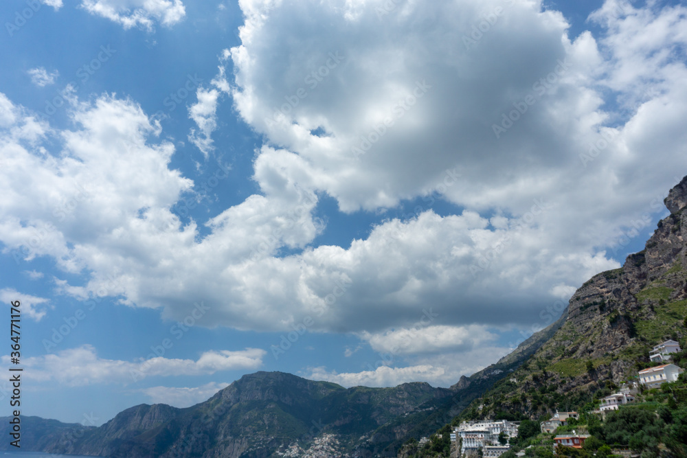 blue sky and clouds above cliff in Italy