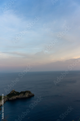 vertical shot of coastline and sea at sunset