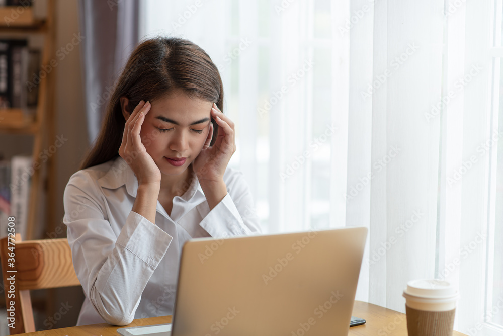 Stressed business woman with palm on face in her office Stressed business woman with palm on face in her office