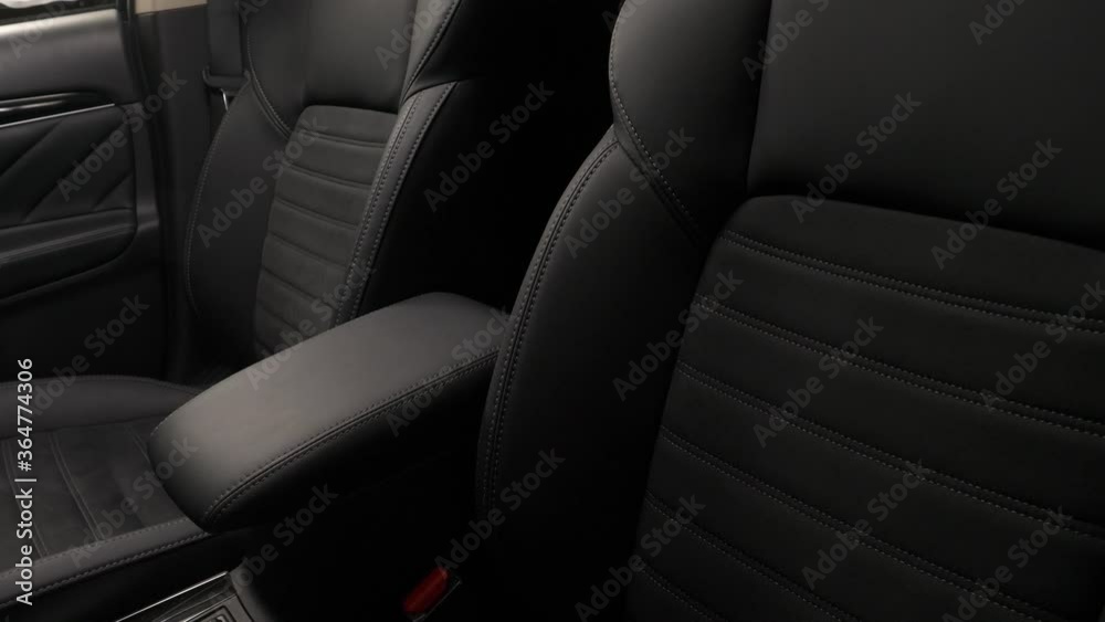 Panning from down to up of the interior of a luxury car with leather upholstery seats and door. Panning from down to up of the interior of a luxury car with leather upholstery seats and door.