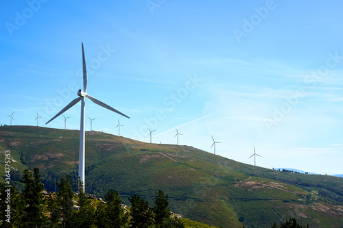 mountains with windmills and blue sky
