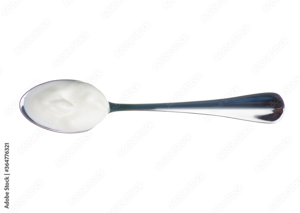 A spoon of sour cream on white background isolation, top view A spoon of sour cream on white background isolation, top view
