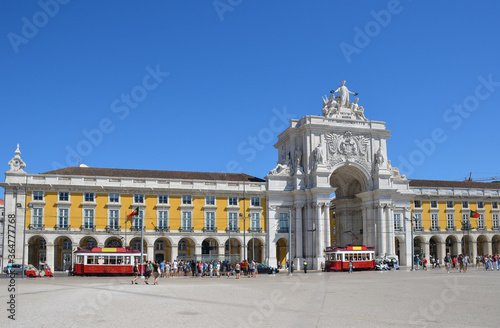 Commerce square (Praca do Comercio) and two red traditional trams, in Lisbon, Portugal