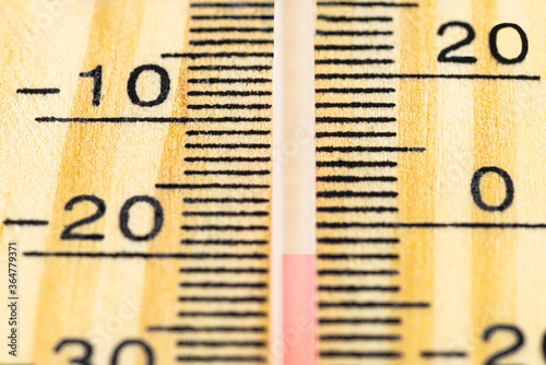 A macro shot of a classic wooden thermometer showing a temperature -20 degrees Celsius, -4 degrees Fahrenheit. photo