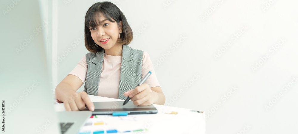 Young creative designer working at office. Graphic designer at work. Color swatch samples.Young female designer using graphics laptop while working with computer.
Young creative designer working at office. Graphic designer at work. Color swatch samples.Young female designer using graphics laptop while working with computer.