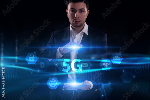 Business, Technology, Internet and network concept. Young businessman working on a virtual screen of the future and sees the inscription: 5G