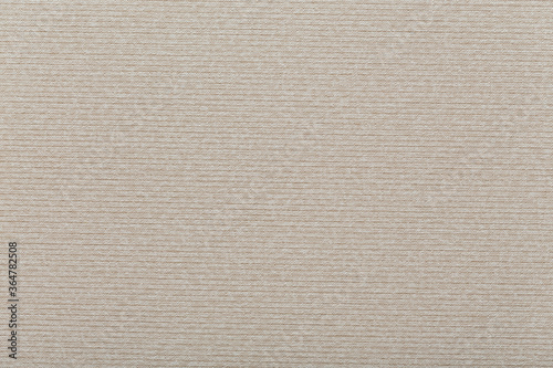 Textile surface of beige color with lines embossed. Background design.