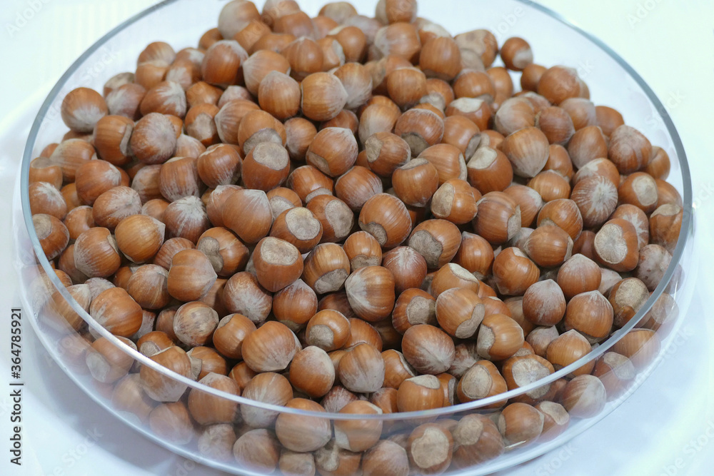 Bunch of hazelnuts in a glass bowl close up view Bunch of hazelnuts in a glass bowl close up view