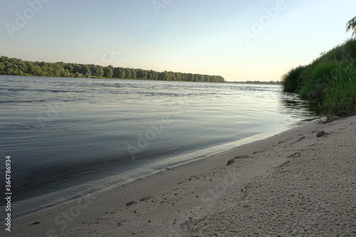 sunrise on the banks of a large river