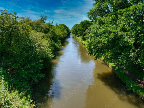 Halsall Cutting on the Leeds to Liverpool canal in Lancashire  UK - a quiet  tranquil section of the canal. Taken on a calm sunny day in summer.