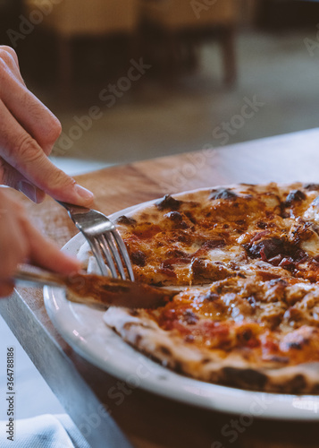 Man cutting pizza close up