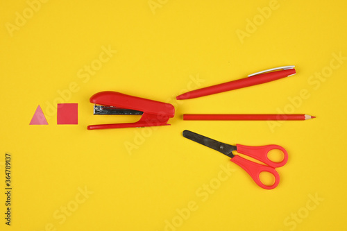 red school supplies on a yellow background
