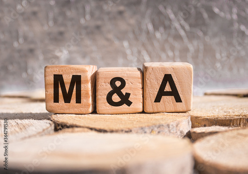 Wooden blocks with the word M&a. Business and finance concept.