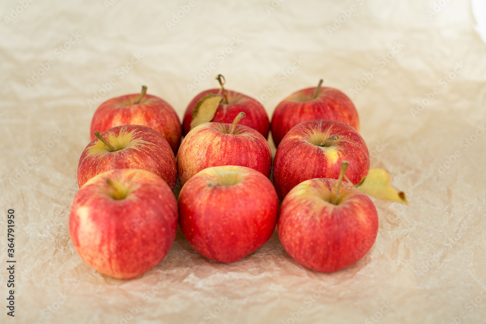Freshly harvested red apples on craft paper background. Local farmers produce. Freshly harvested red apples on craft paper background. Local farmers produce.