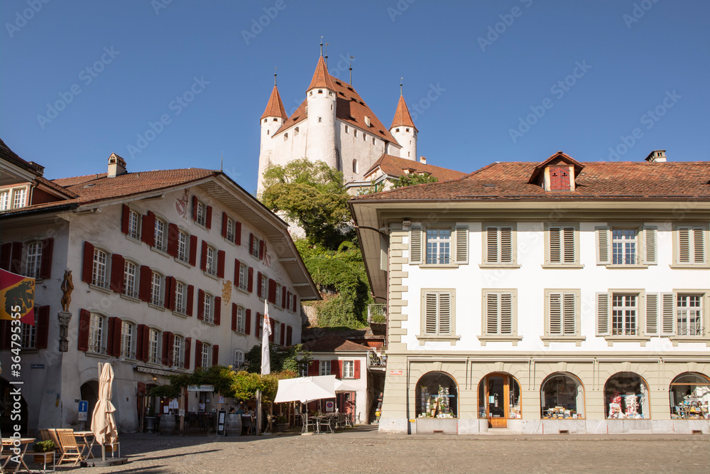Main square in Thun old city, castle on the hill, facades of buildings. Switzerland.