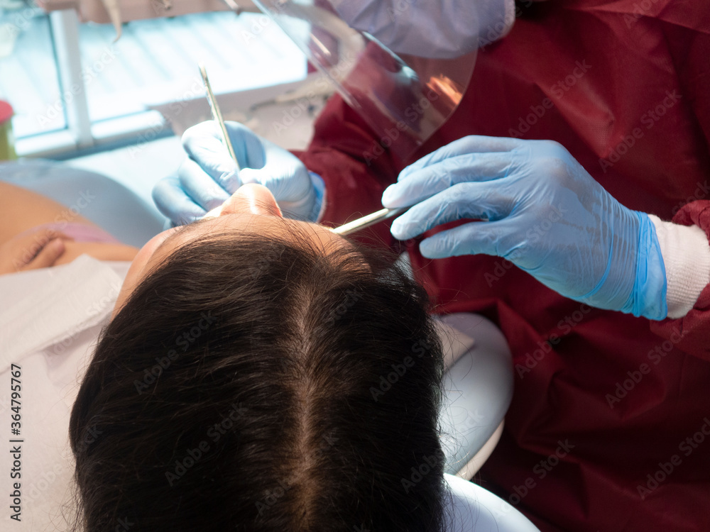 Operation with dental or dental hygienist patient. Woman with calculus or bruise. Oral Doctor wisdom tooth removal. Dentist. Expert business. Operation with dental or dental hygienist patient. Woman with calculus or bruise. Oral Doctor wisdom tooth removal. Dentist. Expert business.